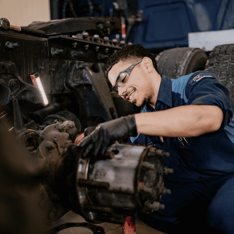 A Hogan technician working on a Hogan truck.