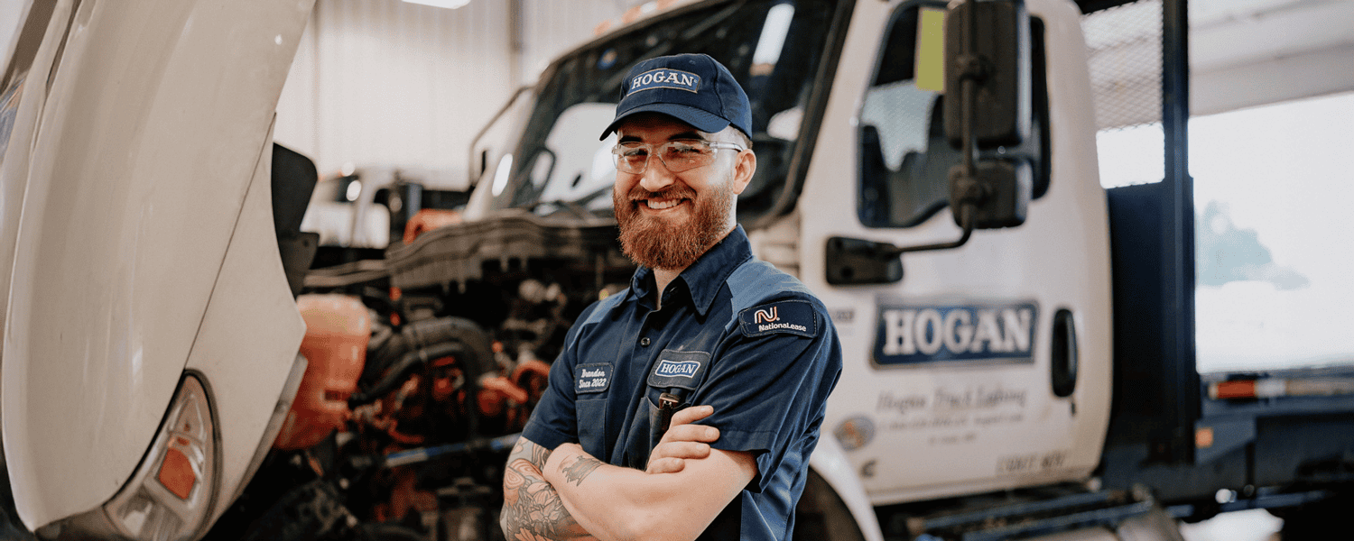 A Hogan technician in front of a Hogan truck.