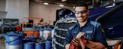 A Hogan technician wiping oil from his hands.