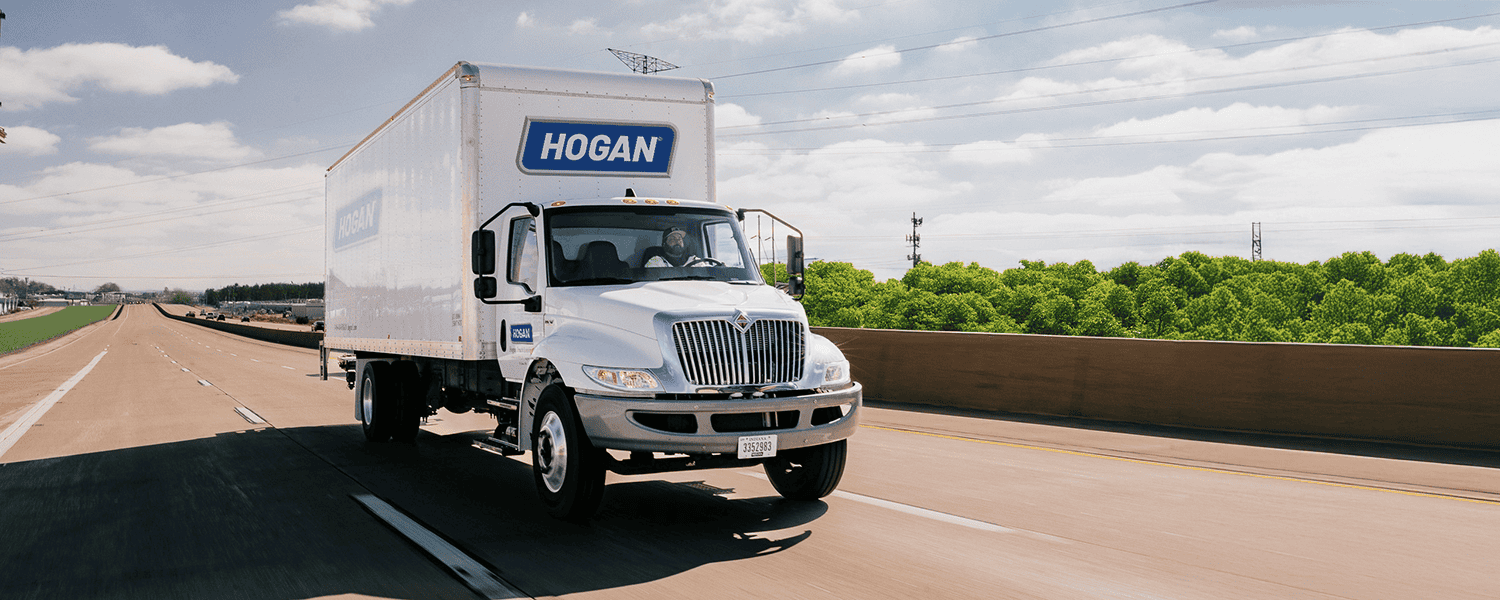 A Hogan truck on the highway in the summer.